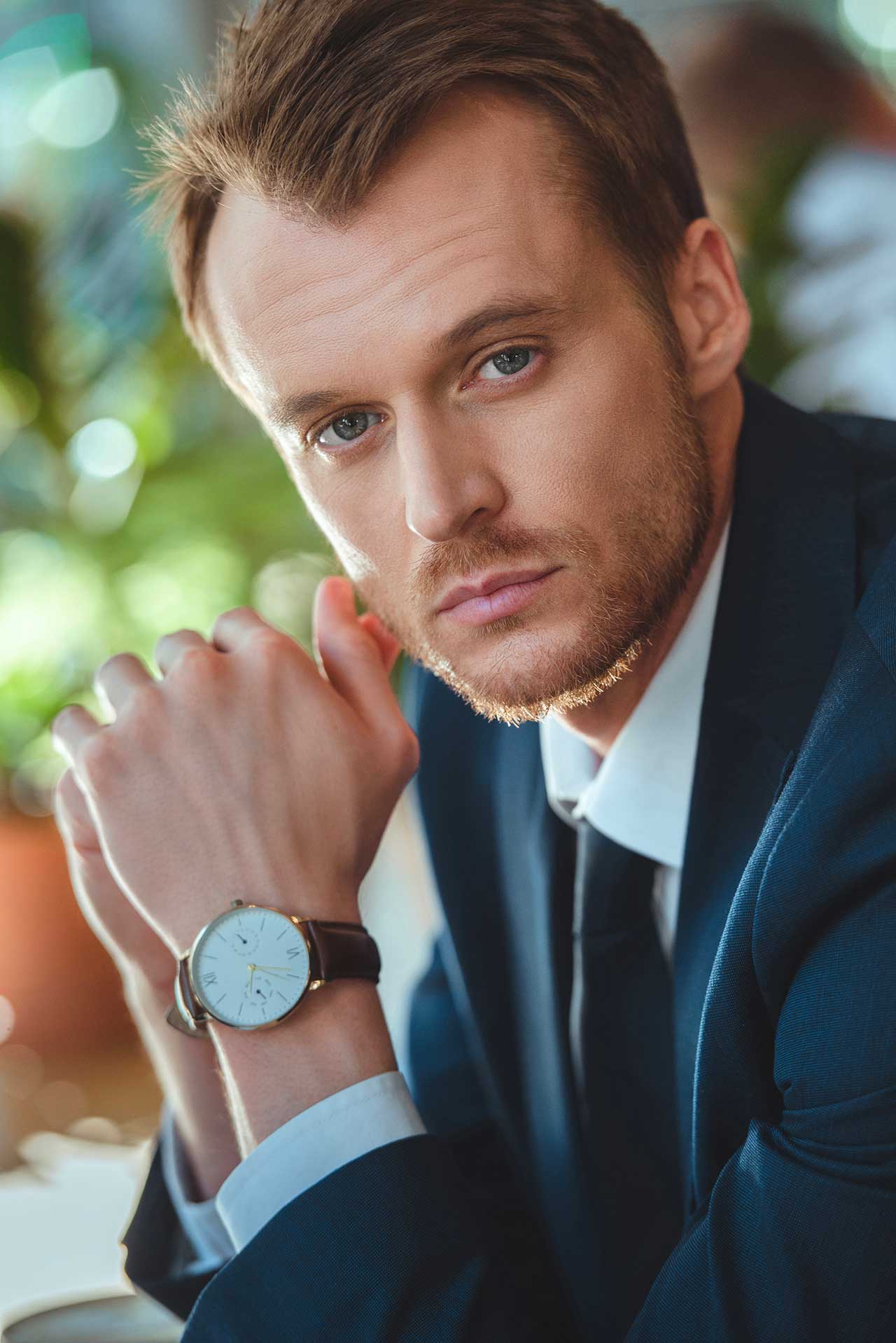 portrait of businessman with watch on wrist lookin 2023 11 27 05 08 52 utc.jpg